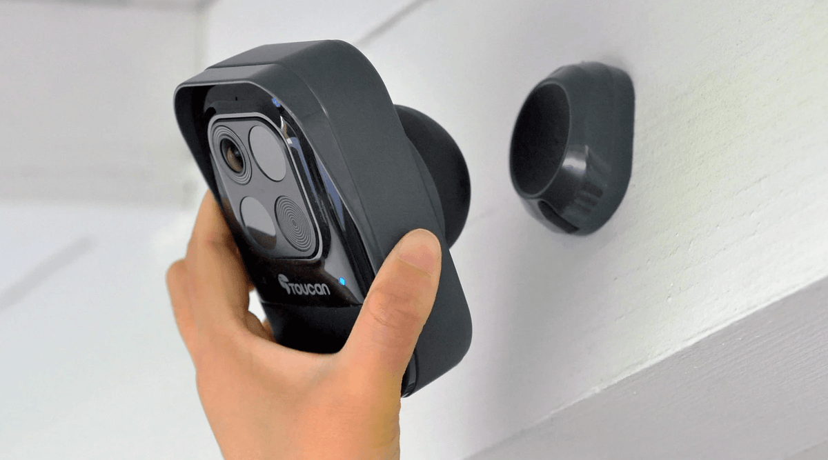 Person installing a Toucan Wireless Security Camera Pro