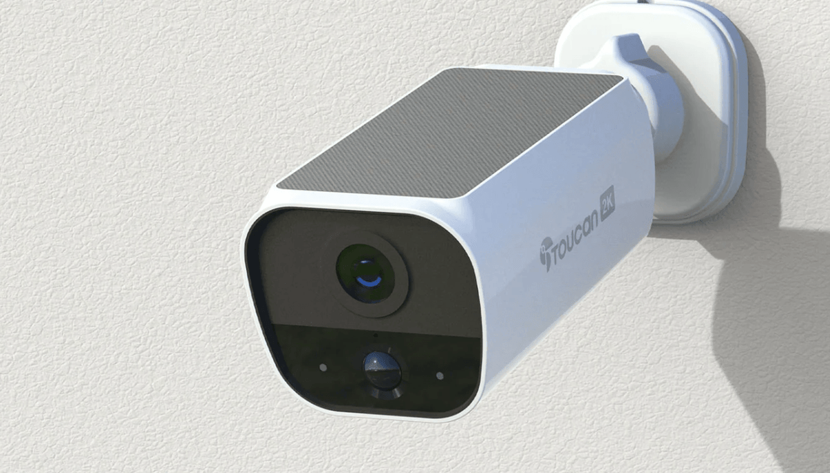 Toucan S5 solar camera installed on a white exterior wall