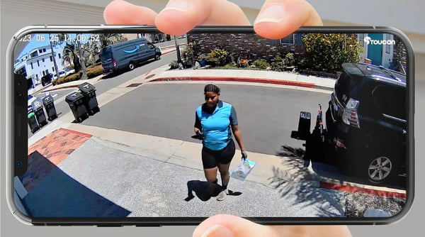 hand holding smart phone with screen showing video from the Toucan Wireless Security Camera PRO