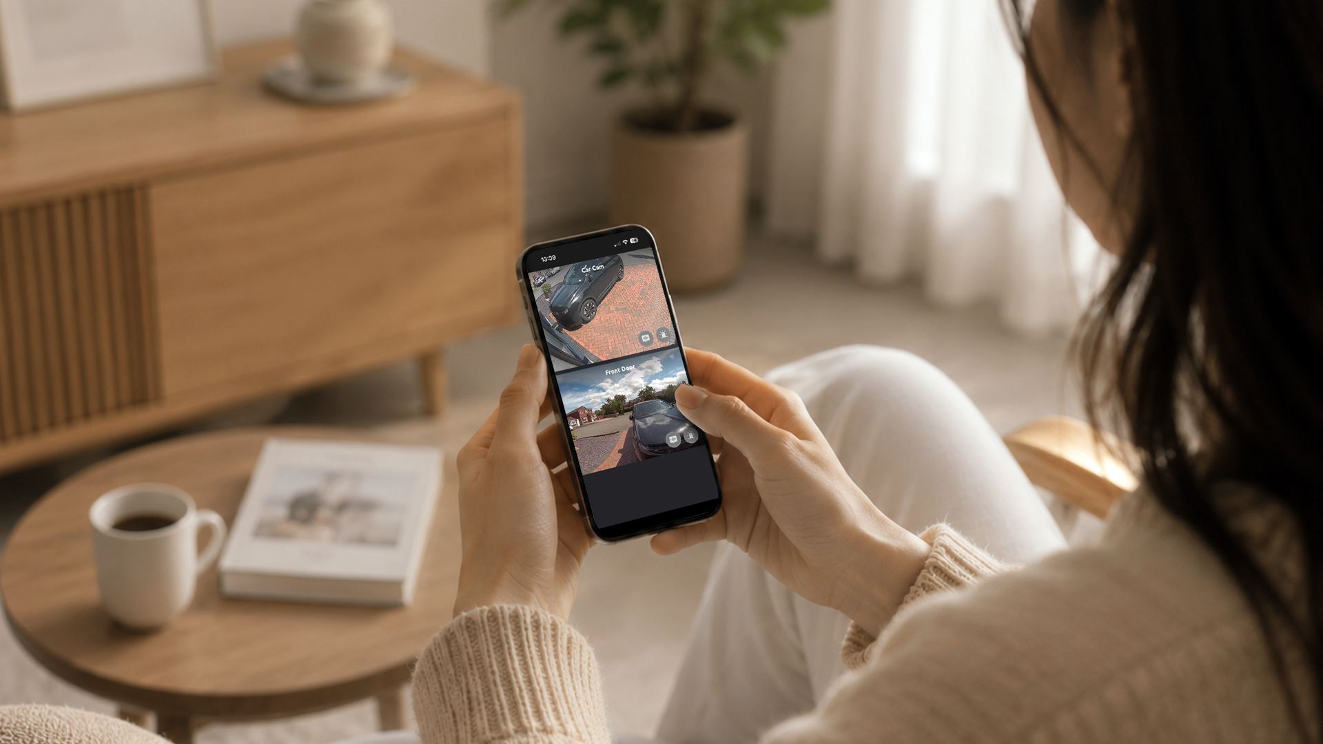 Homeowner viewing two Toucan security camera feeds through the Toucan Smart Home app