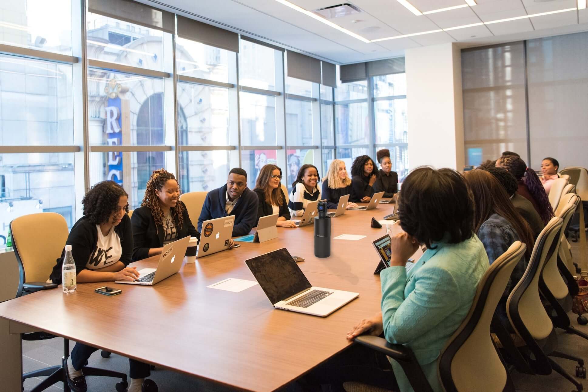5 Ways 360 Conference Cameras Empower Business Offices | large conference room filled with employees with a 360 conference camera on the table
