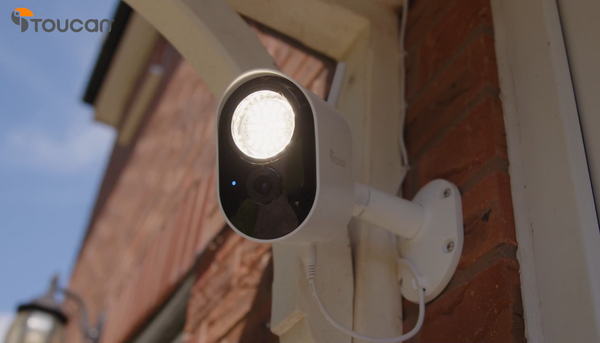 Toucan Solutions' Security Floodlight Camera installed by the main door with the LED lights on