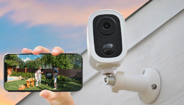 Toucan Wireless Security Camera S4 installed outside a house and a mobile phone screen showing real time feed