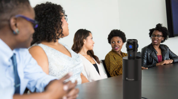 people having a meeting with a 360 conference camera on the table