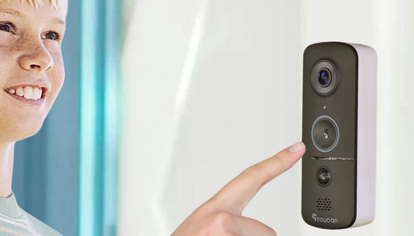 smiling blonde boy about to ring the toucan solutions wireless video doorbell camera v3 installed beside a white front door